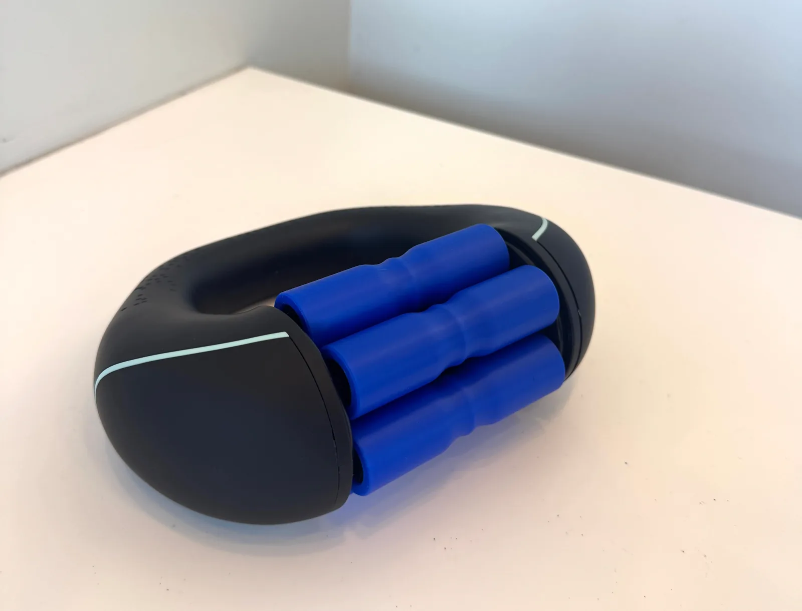 The VascuVive Pulse prototype — a D-shaped handheld device with three long blue rollers
